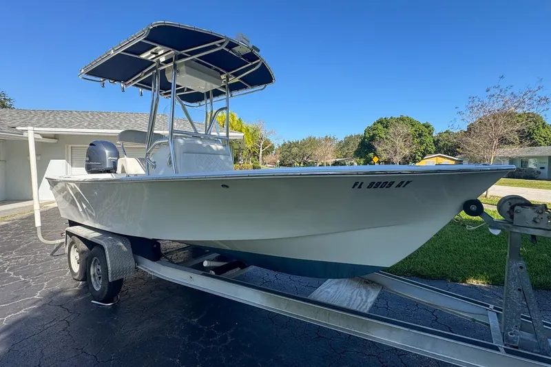 Slide: The Image of 1972 Cuda Craft Open Fisherman boat on trailer, parked in driveway under clear blue sky. - 6