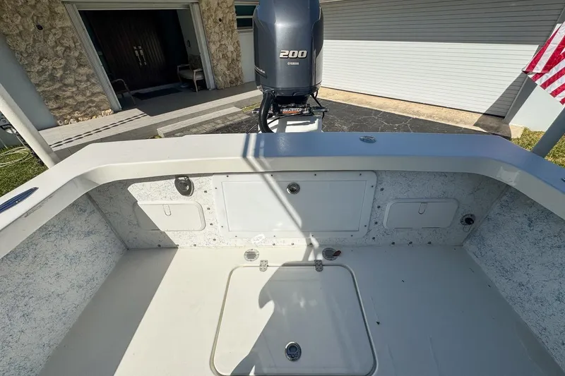 Slide: The Image of 1972 Cuda Craft Open Fisherman boat with Yamaha 200 engine, docked near a garage. - 63