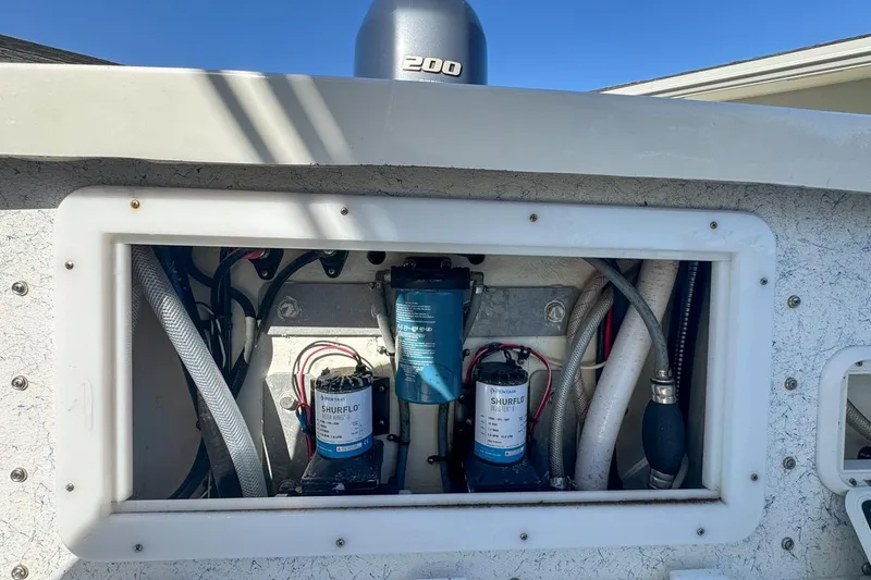 Slide: The Image of 1972 Cuda Craft Open Fisherman boat engine compartment with Shurflo pumps and hoses. - 65