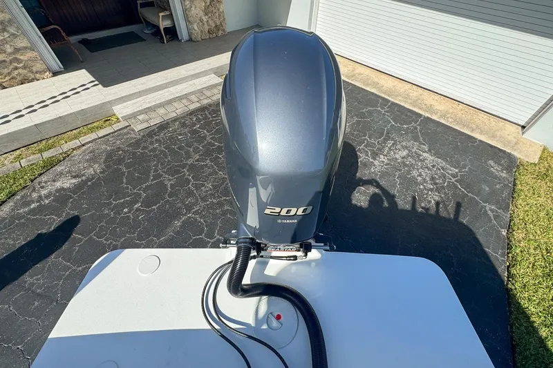 Slide: The Image of 1972 Cuda Craft Open Fisherman with Yamaha 200 outboard motor in driveway. - 70