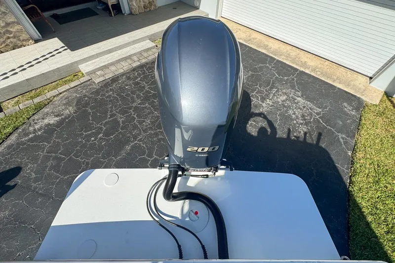 Slide: The Image of 1972 Cuda Craft Open Fisherman with Yamaha 200 outboard motor, parked on driveway. - 71