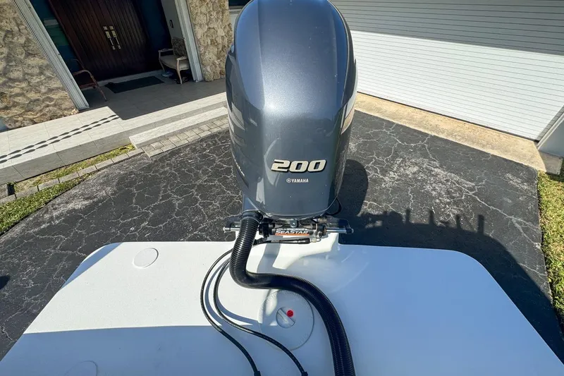 Slide: The Image of 1972 Cuda Craft Open Fisherman with Yamaha 200 outboard motor on driveway. - 72