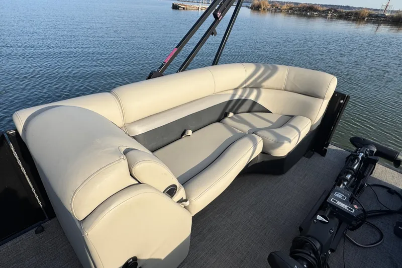 Slide: The Image of 2021 Barletta C22CC pontoon boat with beige seating on a calm lake. - 18