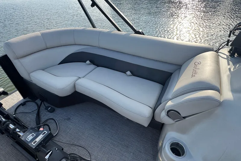 Slide: The Image of 2021 Barletta C22CC boat interior with plush seating and elegant design on the water. - 19