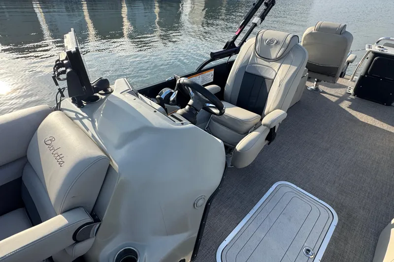 Slide: The Image of 2021 Barletta C22CC boat interior with steering wheel and comfortable seating. - 21