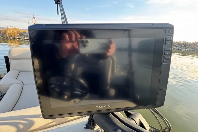 Slide: The Image of Garmin display on 2021 Barletta C22CC boat, reflecting water and sky. - 28