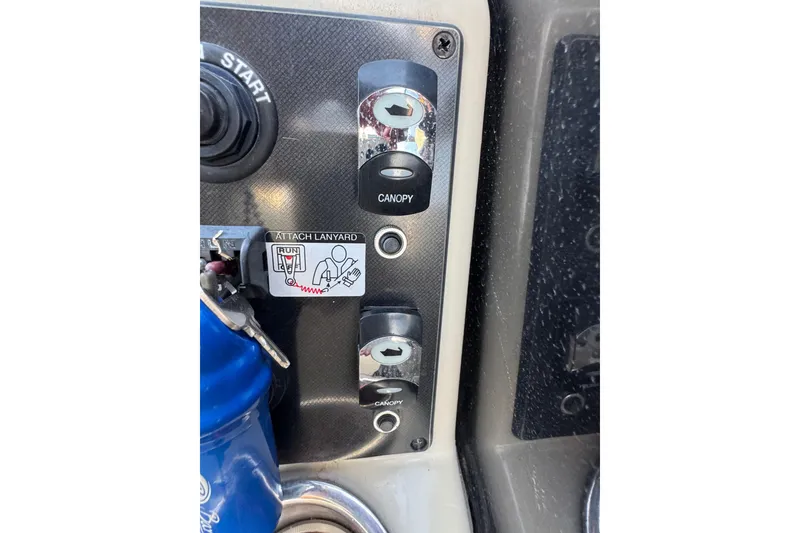 Slide: The Image of Control panel of 2021 Barletta C22CC boat with canopy switches and ignition key. - 30