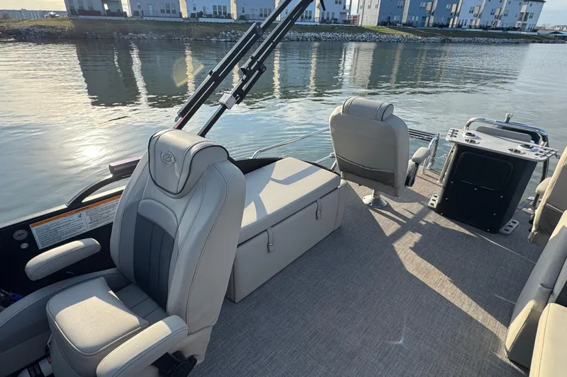 Slide: The Image of 2021 Barletta C22CC boat interior with comfortable seating on a calm lake. - 32