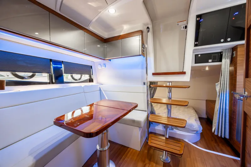 Slide: The Image of Boston Whaler 405 Conquest 2021 boat deck with cushioned seating on calm water. - 14