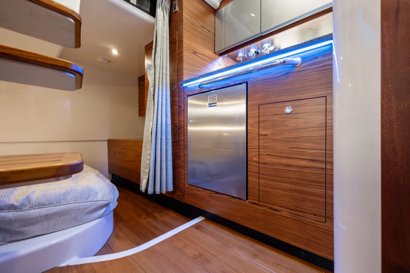 Slide: The Image of Interior of 2021 Boston Whaler 405 Conquest yacht, featuring modern seating and wooden accents. - 18