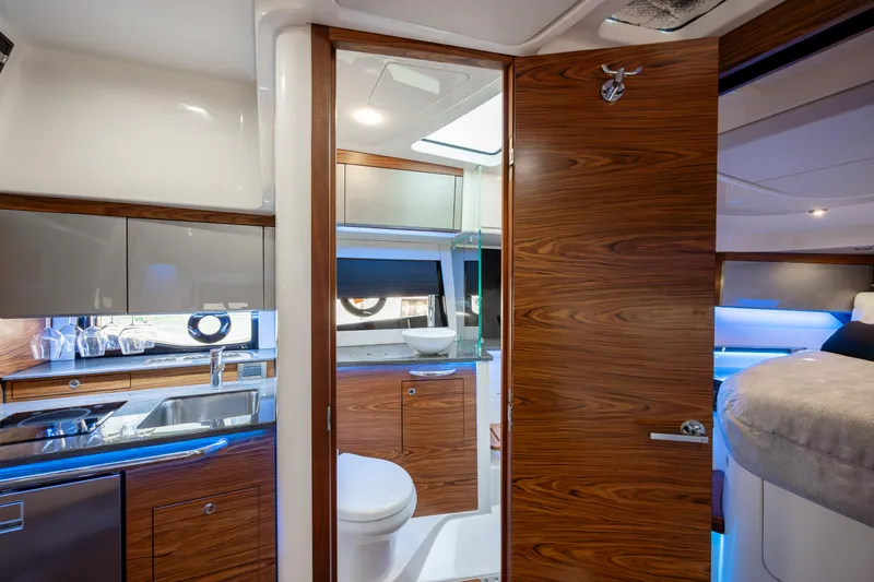Slide: The Image of Luxurious interior of 2021 Boston Whaler 405 Conquest yacht with modern kitchen and seating area. - 19