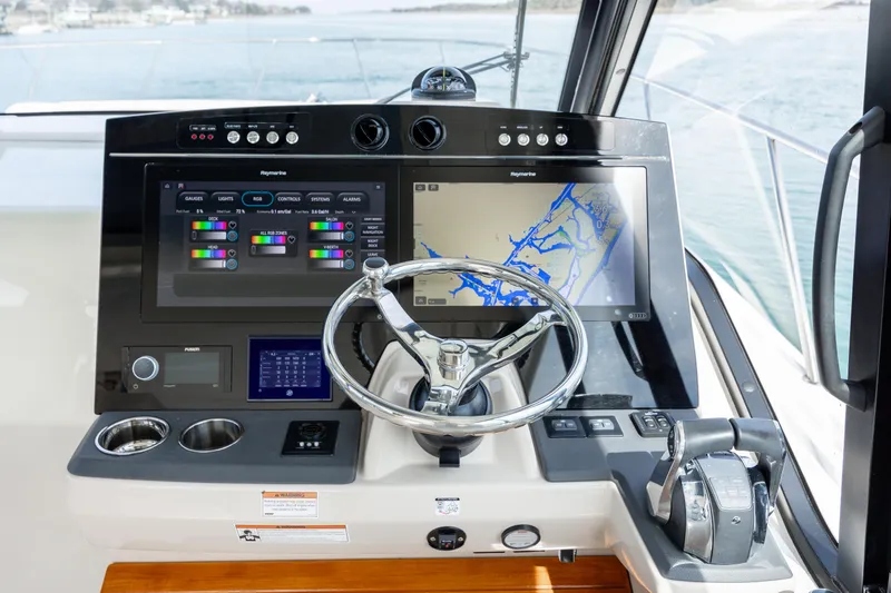 Slide: The Image of 2021 Boston Whaler 405 Conquest boat on stands, blue hull, outdoor storage. - 2