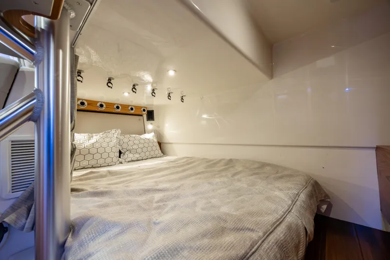 Slide: The Image of Luxurious cabin interior of 2021 Boston Whaler 405 Conquest with modern lighting and cozy bedding. - 28