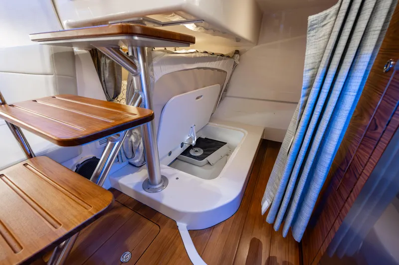 Slide: The Image of Luxurious interior of 2021 Boston Whaler 405 Conquest yacht, featuring wood accents and modern amenities. - 30
