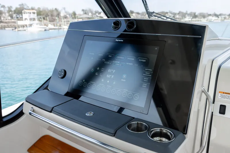 Slide: The Image of Interior of 2021 Boston Whaler 405 Conquest, featuring modern wood cabinetry and compact kitchen area. - 33