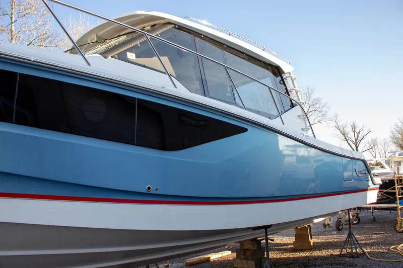 Slide: The Image of 2021 Boston Whaler 405 Conquest boat with sleek blue hull and modern design. - 40