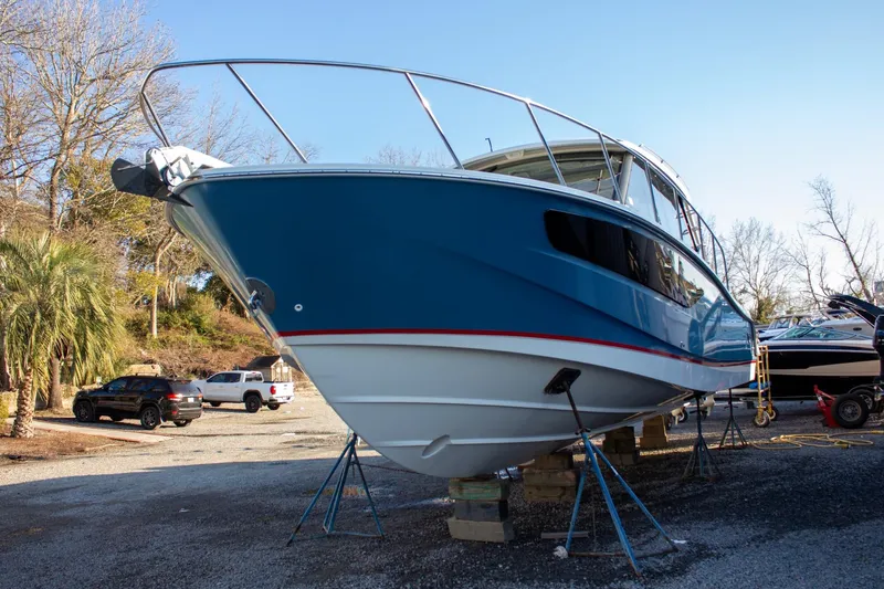 Slide: The Image of 2021 Boston Whaler 405 Conquest boat on stands, blue hull, outdoor setting. - 41
