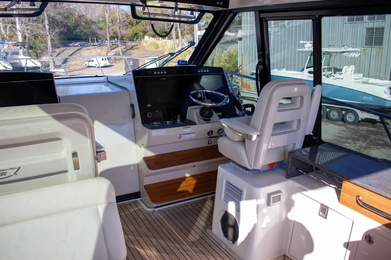 Slide: The Image of Interior view of 2021 Boston Whaler 405 Conquest boat cockpit with steering wheel and controls. - 42