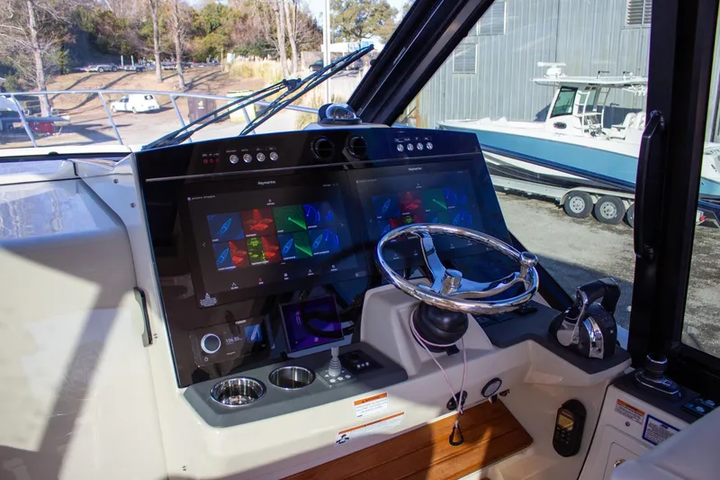 Slide: The Image of 2021 Boston Whaler 405 Conquest helm with advanced navigation system and steering wheel. - 43