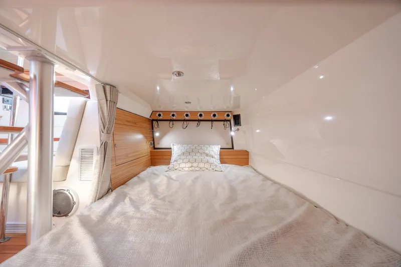 Slide: The Image of 2021 Boston Whaler 405 Conquest cabin interior with cozy bed and modern design. - 54