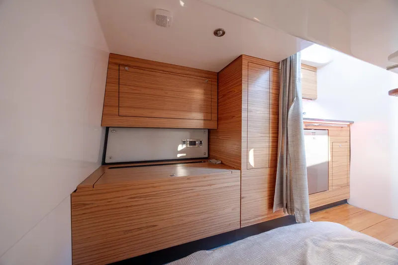 Slide: The Image of Interior of 2021 Boston Whaler 405 Conquest, featuring sleek wooden cabinetry and modern design. - 55