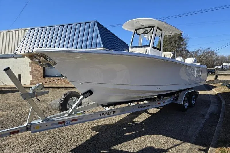 The Image of 2026 Sea Hunt Ultra 275 Coffin Box boat on trailer, parked outdoors. - 0