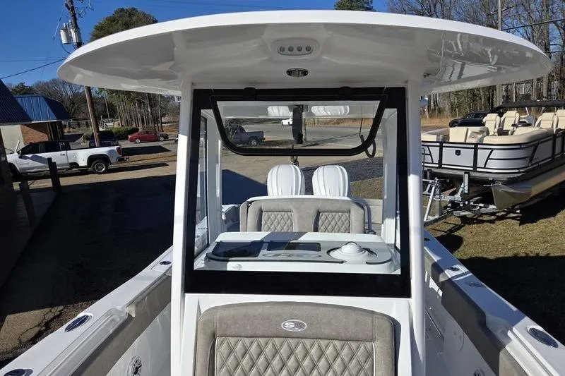 Slide: The Image of 2026 Sea Hunt Ultra 275 Coffin Box boat, featuring a sleek console and seating area. - 11