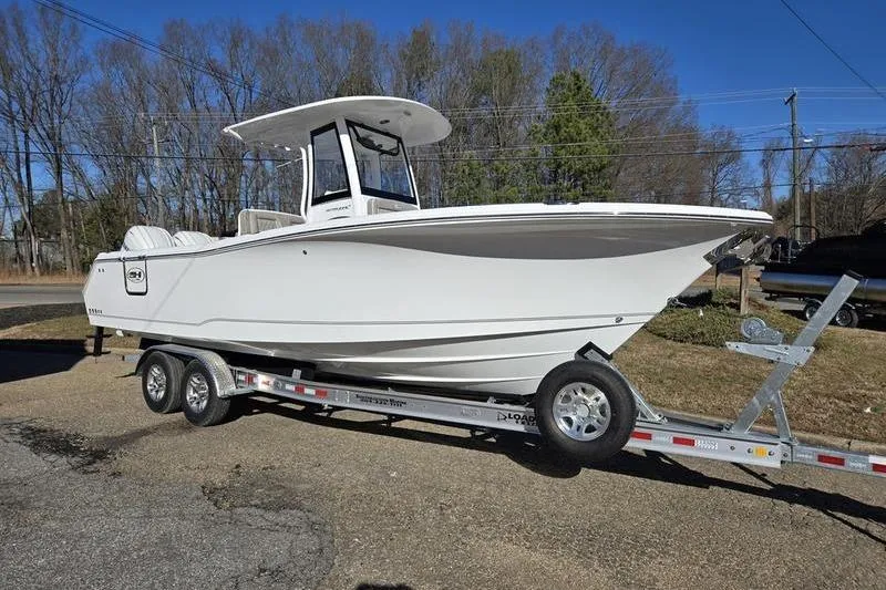 Slide: The Image of 2026 Sea Hunt Ultra 275 Coffin Box boat on trailer, parked outdoors. - 14