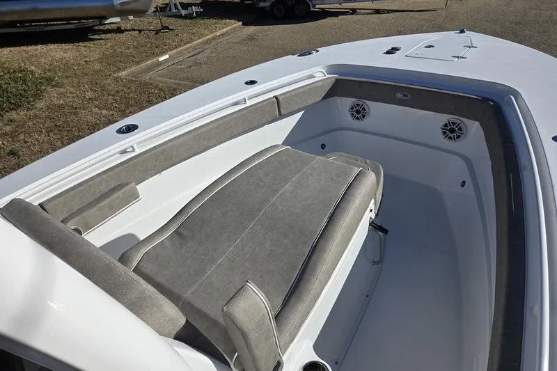 Slide: The Image of 2026 Sea Hunt Ultra 275 Coffin Box boat interior with cushioned seating and speakers. - 16