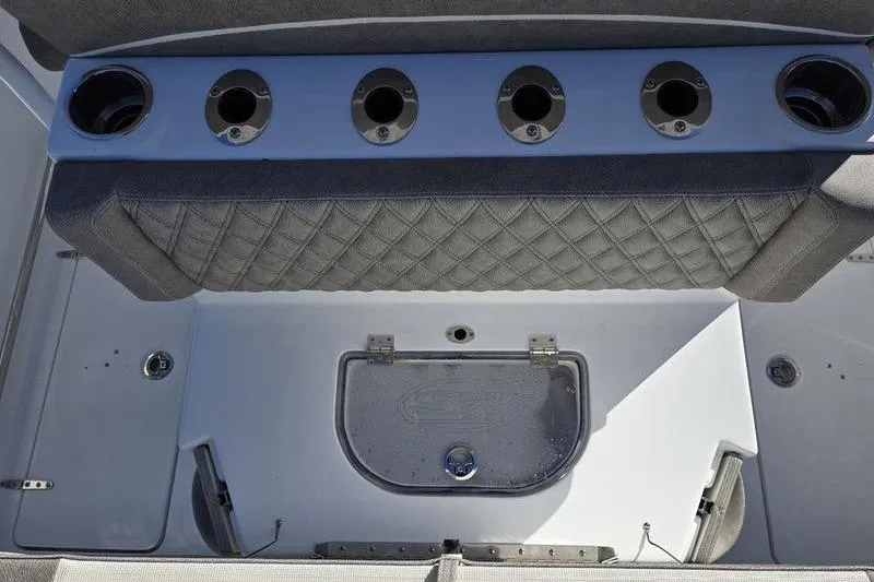Slide: The Image of 2026 Sea Hunt Ultra 275 Coffin Box interior with rod holders and storage compartment. - 3