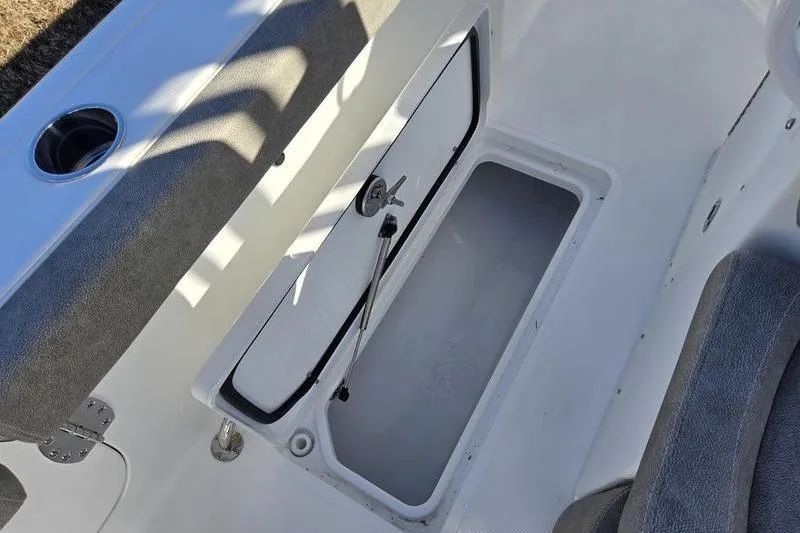 Slide: The Image of 2026 Sea Hunt Ultra 275 Coffin Box open storage compartment with cushioned seating. - 5