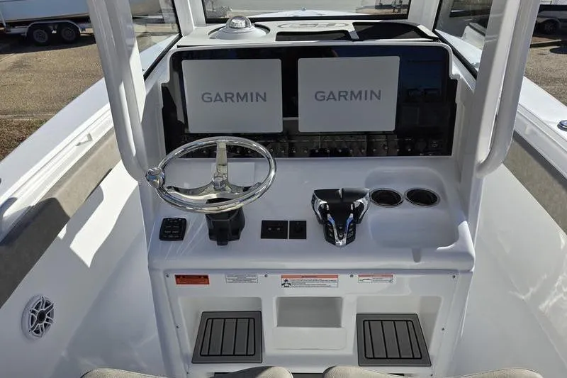 Slide: The Image of 2026 Sea Hunt Ultra 275 Coffin Box boat dashboard with dual Garmin displays. - 6