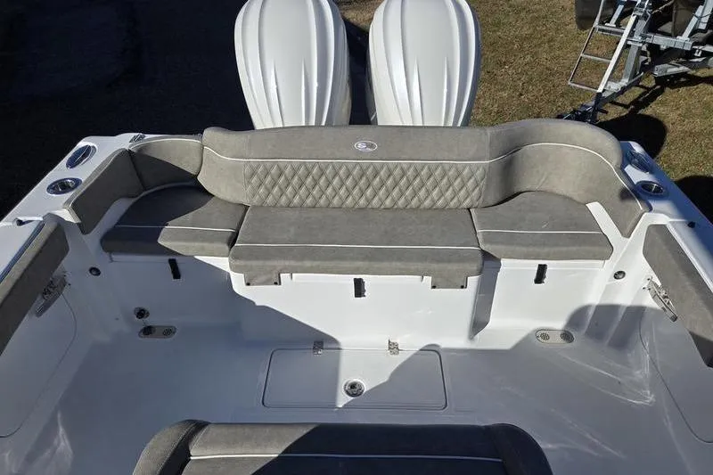 Slide: The Image of 2026 Sea Hunt Ultra 275 Coffin Box boat interior with cushioned seating and storage compartments. - 7