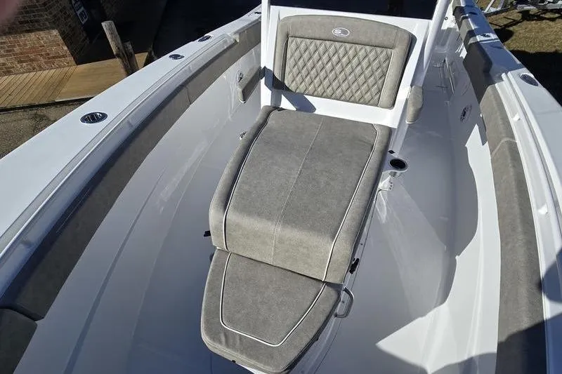 Slide: The Image of 2026 Sea Hunt Ultra 275 Coffin Box boat interior with cushioned seating. - 8