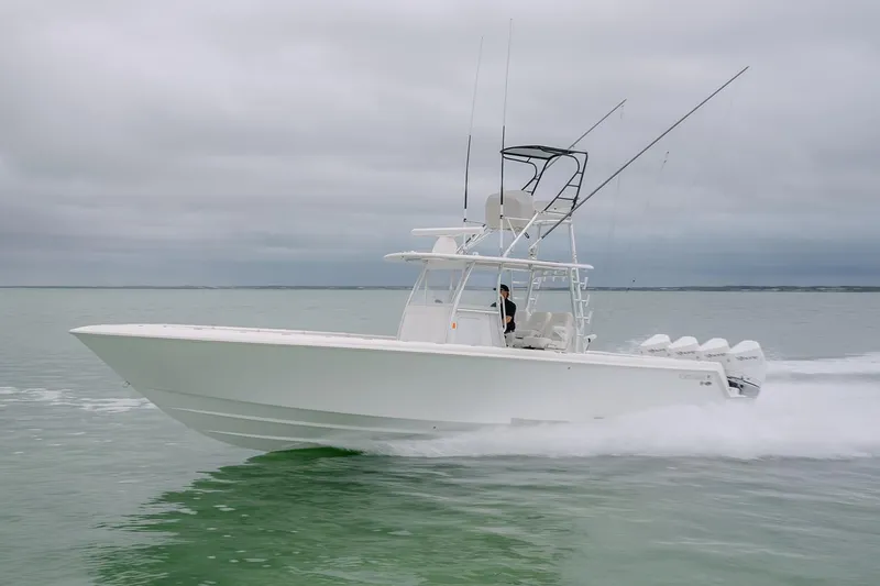 The Image of 2023 Contender 39 ST boat cruising on calm waters under cloudy skies. - 0