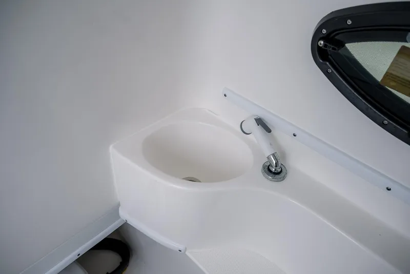 Slide: The Image of 2023 Contender 39 ST boat interior sink with faucet and window. - 17