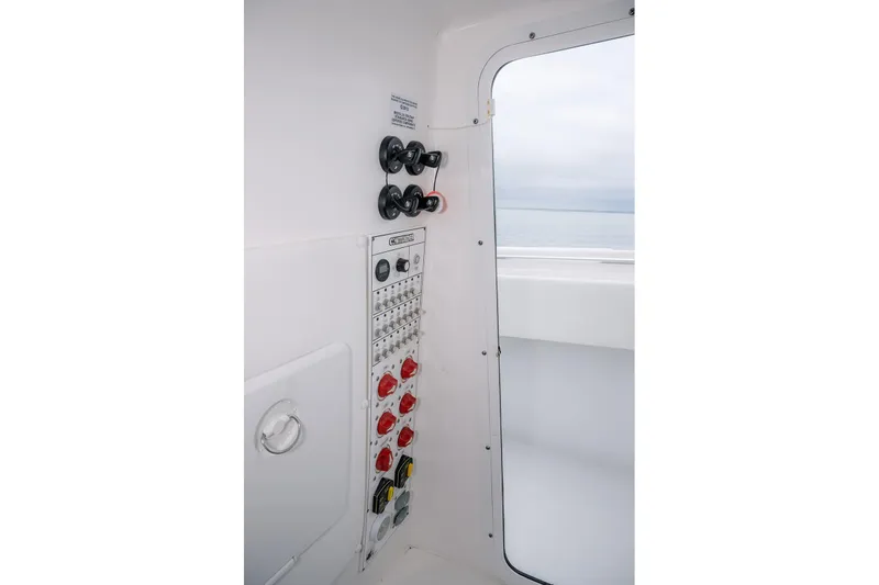 Slide: The Image of Control panel of 2023 Contender 39 ST boat, featuring switches and dials. - 19