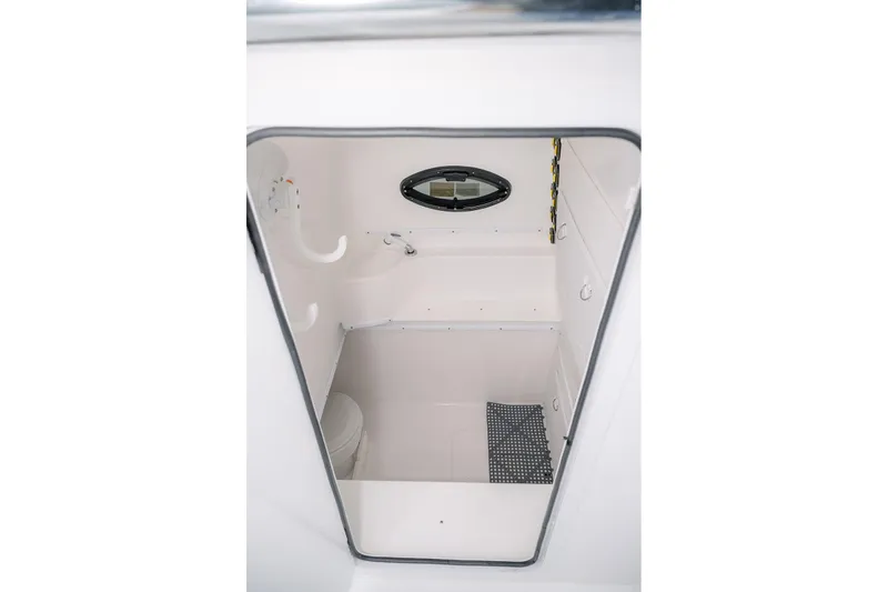 Slide: The Image of 2023 Contender 39 ST boat interior cabin with compact toilet and window. - 20