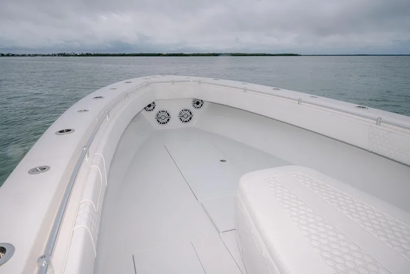 Slide: The Image of 2023 Contender 39 ST boat interior with white seating and ocean view. - 21