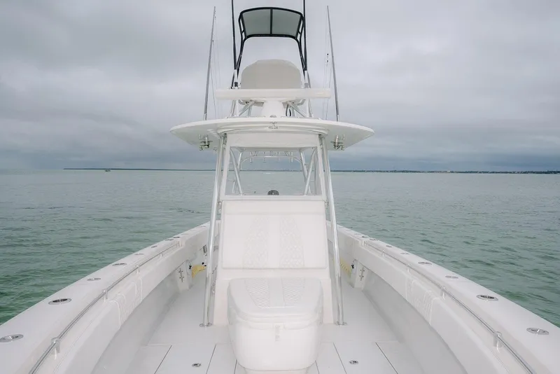 Slide: The Image of 2023 Contender 39 ST boat on calm waters under cloudy skies. - 26