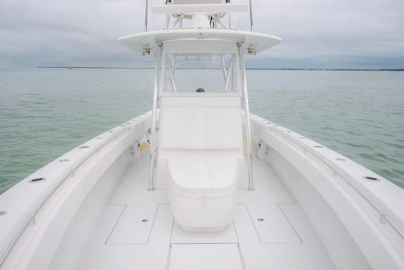 Slide: The Image of 2023 Contender 39 ST boat on calm water, showcasing sleek design and spacious deck. - 27