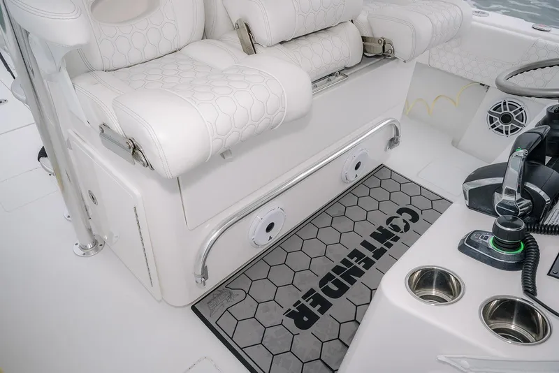 Slide: The Image of 2023 Contender 39 ST boat interior with white seating and control panel. - 30