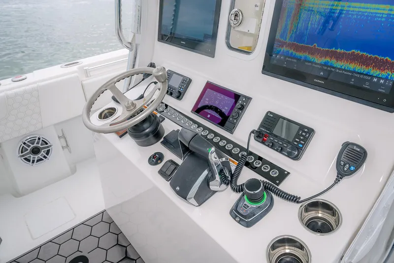 Slide: The Image of 2023 Contender 39 ST boat dashboard with advanced navigation and control systems. - 31
