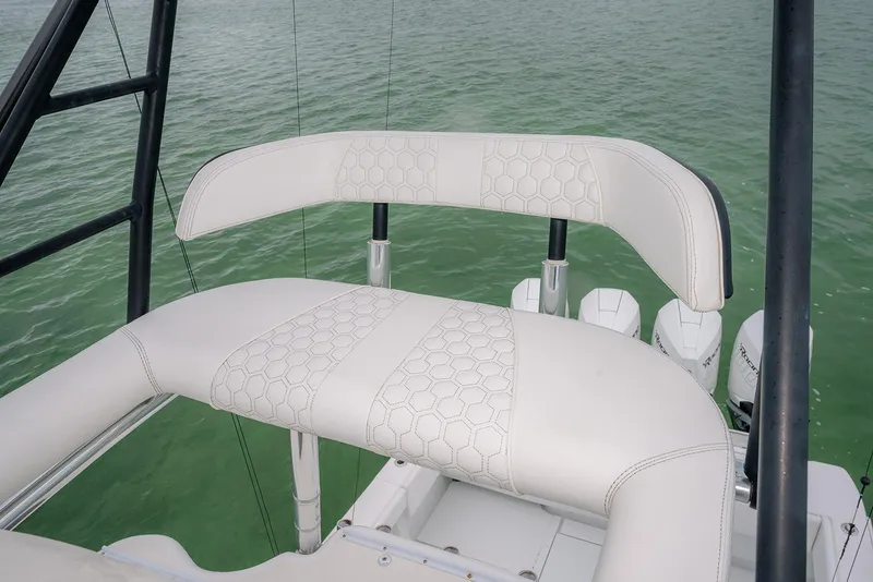 Slide: The Image of 2023 Contender 39 ST boat seat with hexagonal pattern, overlooking water. - 37