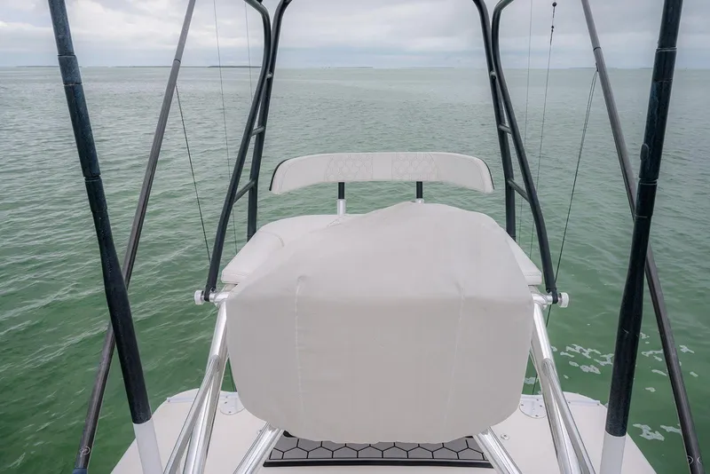 Slide: The Image of 2023 Contender 39 ST boat helm overlooking calm green waters. - 40