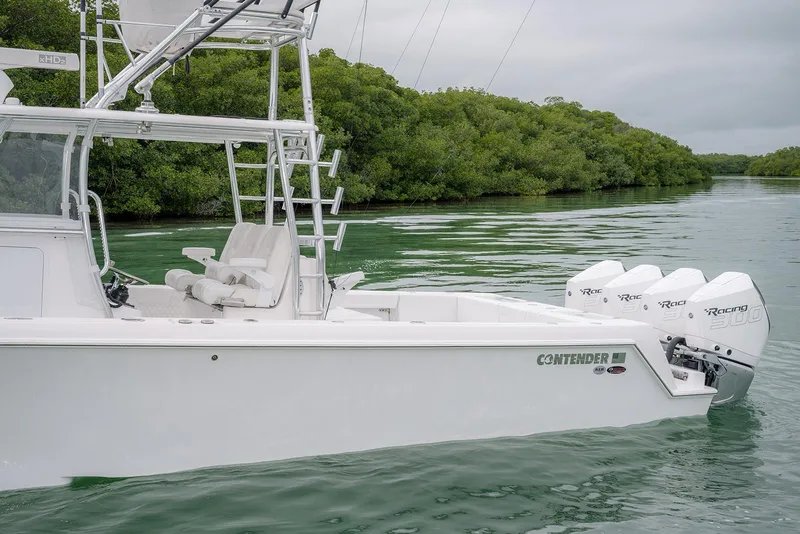 Slide: The Image of 2023 Contender 39 ST boat with triple engines on a calm waterway. - 5