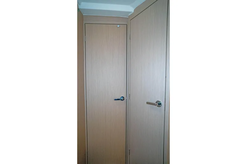Slide: The Image of Interior doors of 2022 Beneteau Oceanis 461 yacht, featuring sleek wooden finish. - 16