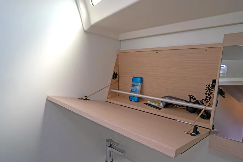 Slide: The Image of Beneteau Oceanis 461 2022 bathroom cabinet with toiletries and mirror. - 26