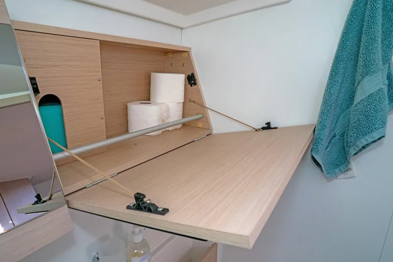 Slide: The Image of Cabinet interior on 2022 Beneteau Oceanis 461 yacht with toiletries and towel. - 27