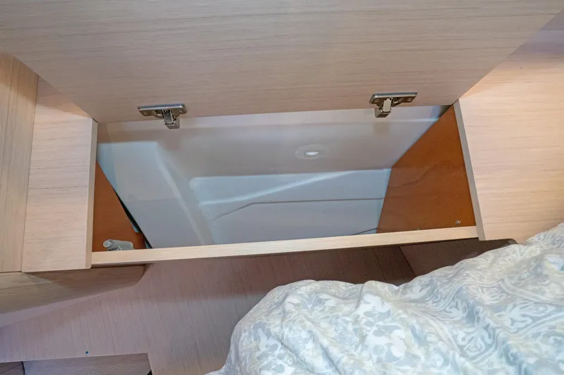 Slide: The Image of Storage compartment in 2022 Beneteau Oceanis 461 sailboat, featuring light wood finish. - 28
